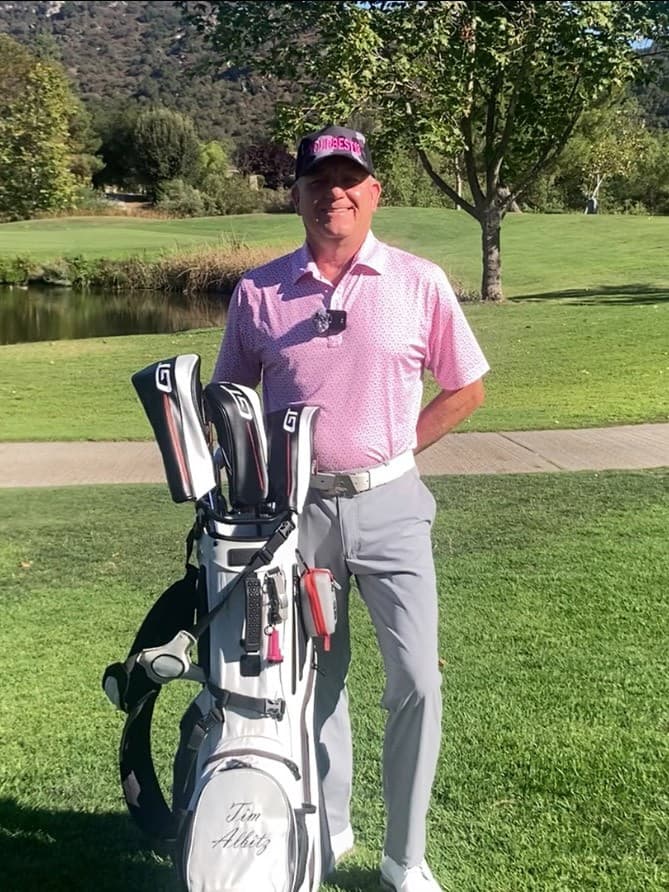 Tim standing by tree