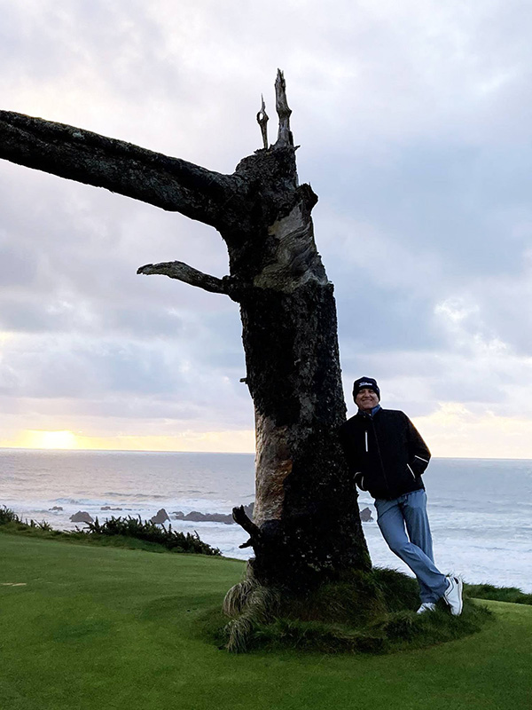 Tim standing by tree